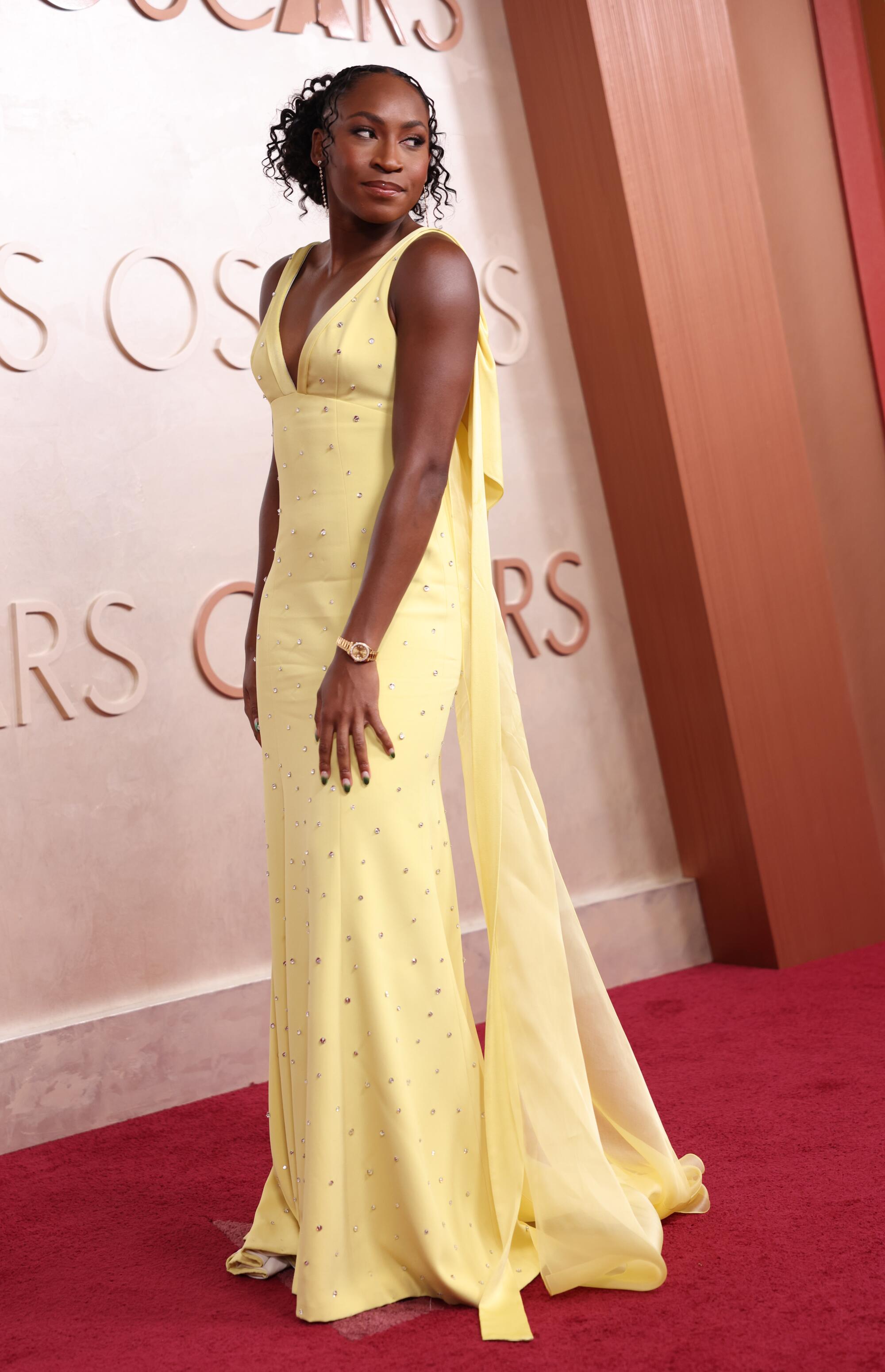 Coco Gauff in a yellow gown on the red carpet