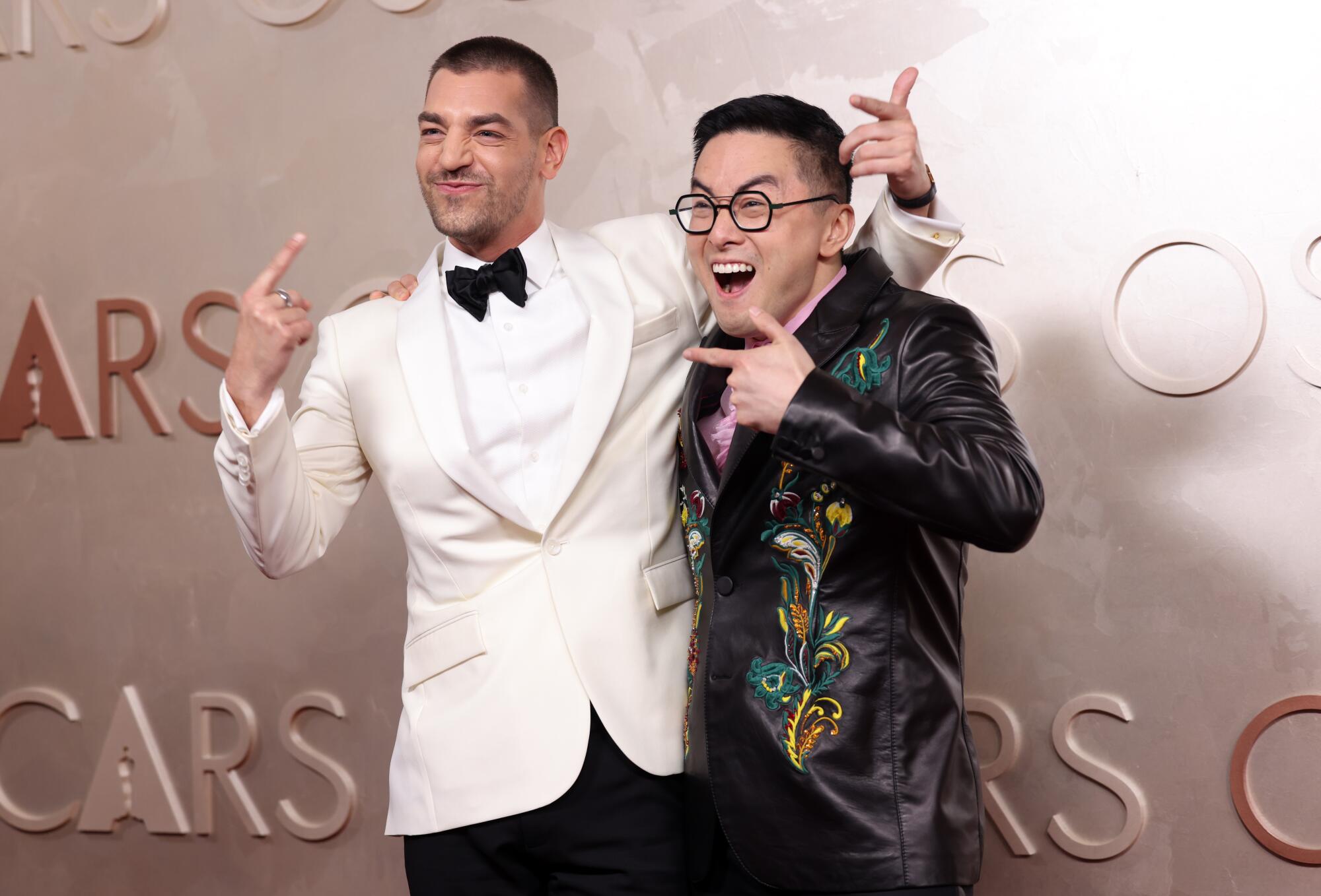 Matt Rogers and Bowen Yang pose on the red carpet. (Christin House / Los Angeles Times)