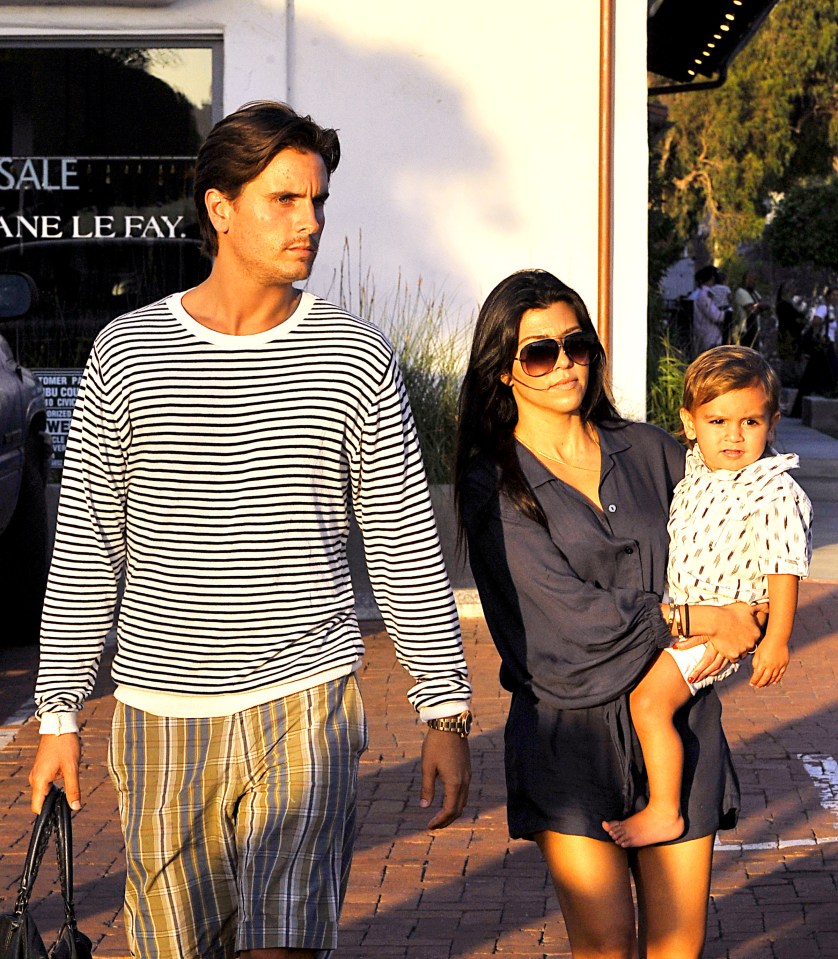 Scott Disick, Kourtney Kardashian, and their son Mason walking.