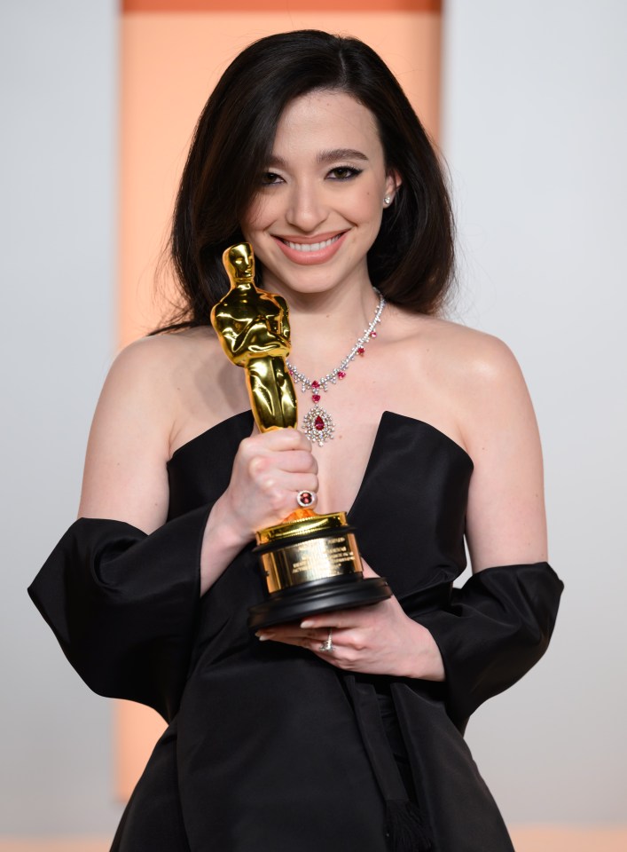 Mikey Madison holding an Academy Award.