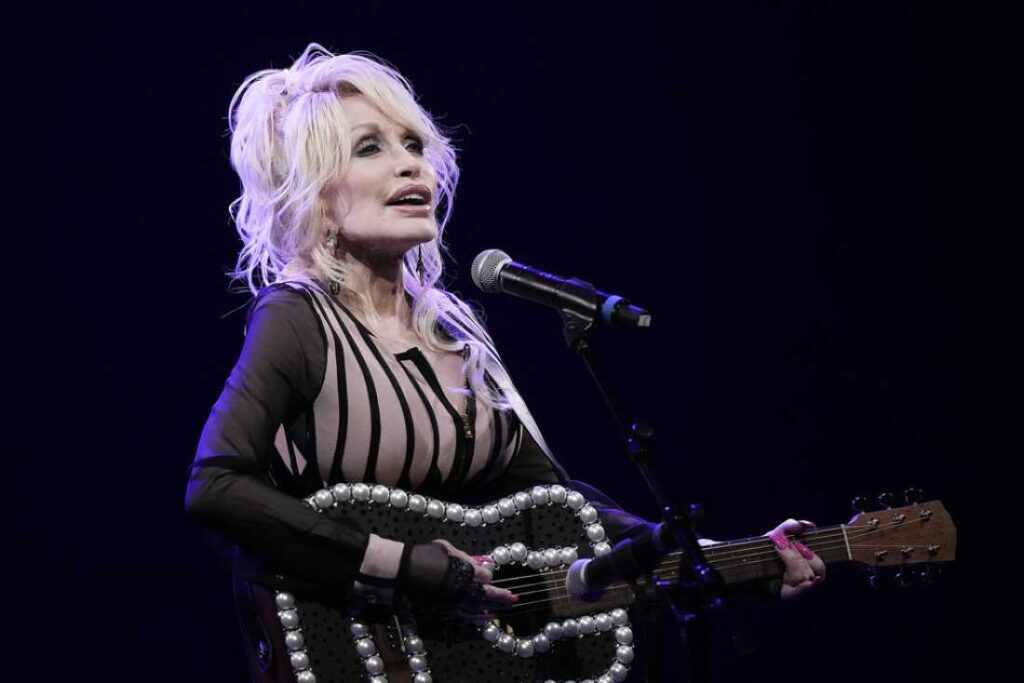 Dolly Parton performs during an event in August 2023 celebrating the Kansas statewide expansion of Dolly Parton's Imagination Library in Overland Park, Kan. Carl Dean, Dolly Parton's husband of nearly 60 years, died Monday in Nashville, Tenn., at age 82.