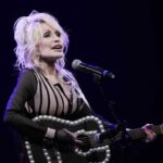 Dolly Parton performs during an event in August 2023 celebrating the Kansas statewide expansion of Dolly Parton's Imagination Library in Overland Park, Kan. Carl Dean, Dolly Parton's husband of nearly 60 years, died Monday in Nashville, Tenn., at age 82.