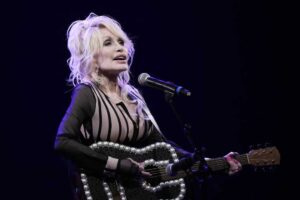 Dolly Parton performs during an event in August 2023 celebrating the Kansas statewide expansion of Dolly Parton's Imagination Library in Overland Park, Kan. Carl Dean, Dolly Parton's husband of nearly 60 years, died Monday in Nashville, Tenn., at age 82.