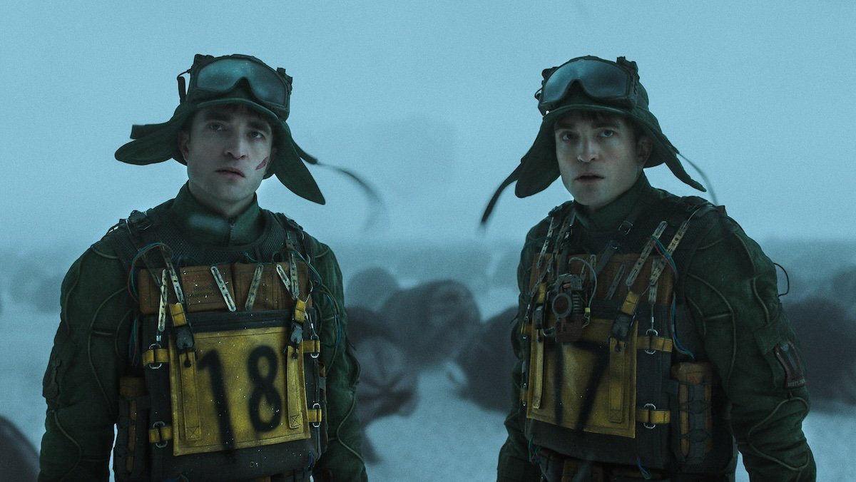 Two Robert Pattinsons in armor out in the snow with aliens in Mickey 17