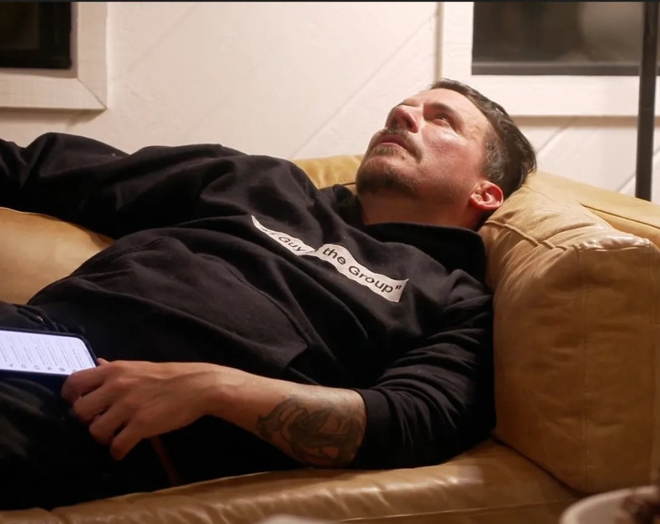 Jax Taylor lying on a couch, looking upward.