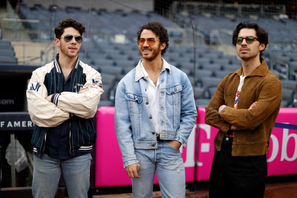 The Jonas Brothers at a baseball game.