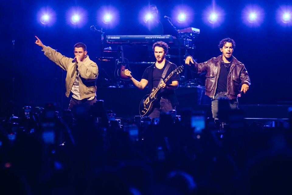 The Jonas Brothers performing on stage.