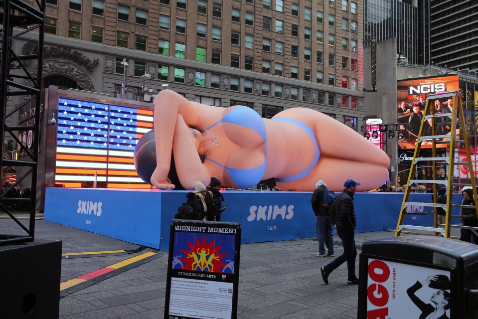 Giant inflatable woman in a blue bikini in Times Square advertising Skims Swim.