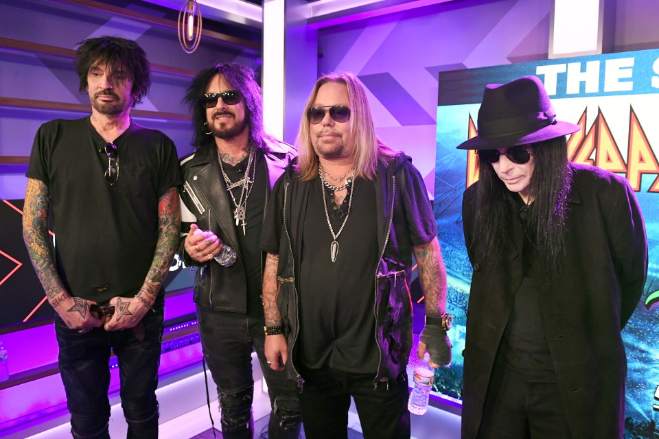 Mötley Crüe members Tommy Lee, Nikki Sixx, Vince Neil, and Mick Mars at a press conference.