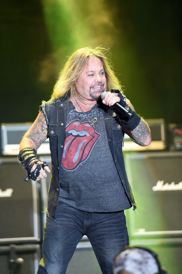 Vince Neil of Mötley Crüe performing on stage.