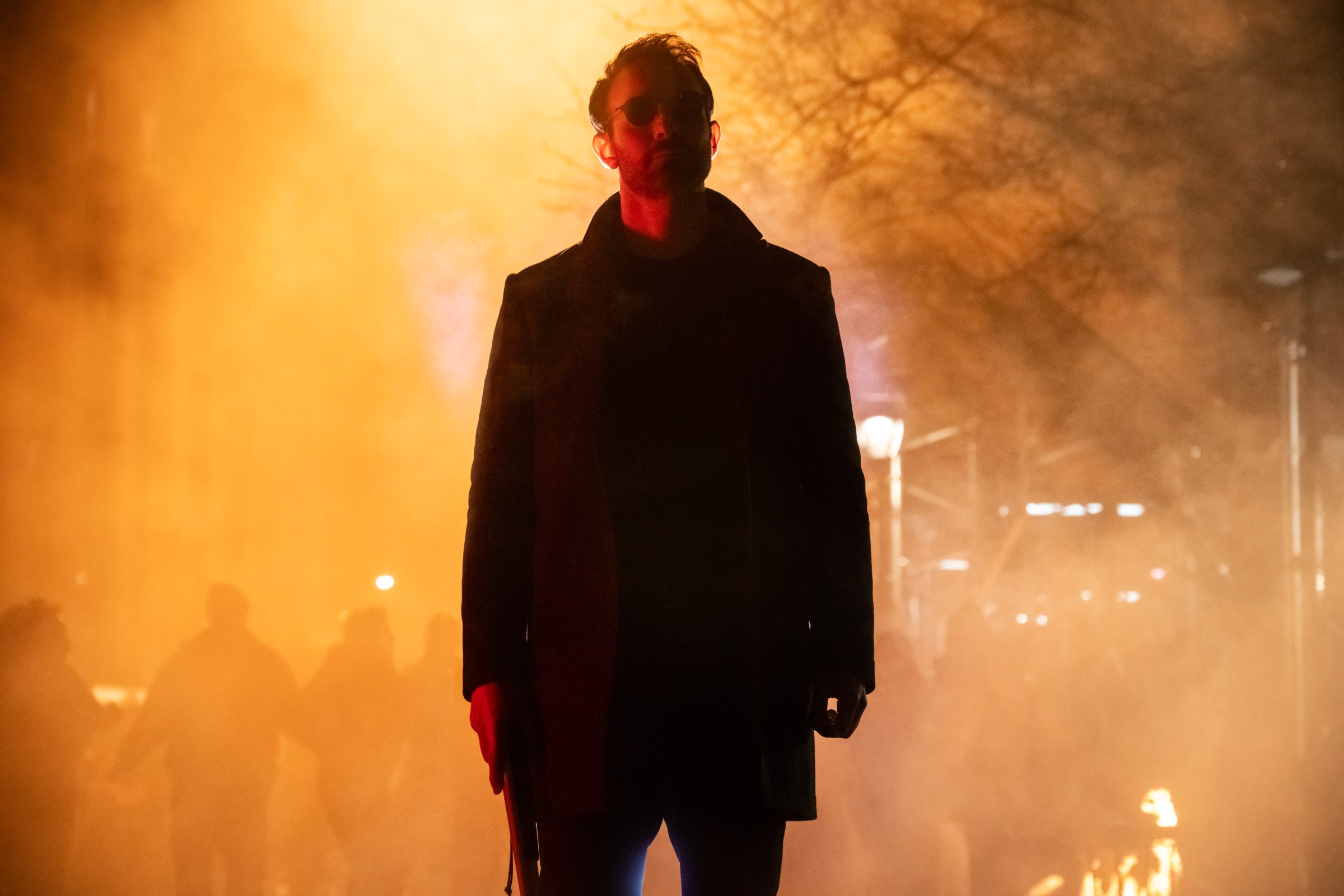 Matt Murdock (Charlie Cox) standing and looking cool with a light coming behind him in Born Again