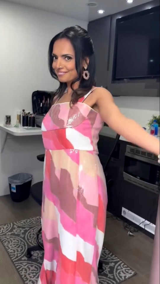 Woman in pink and white patterned dress.