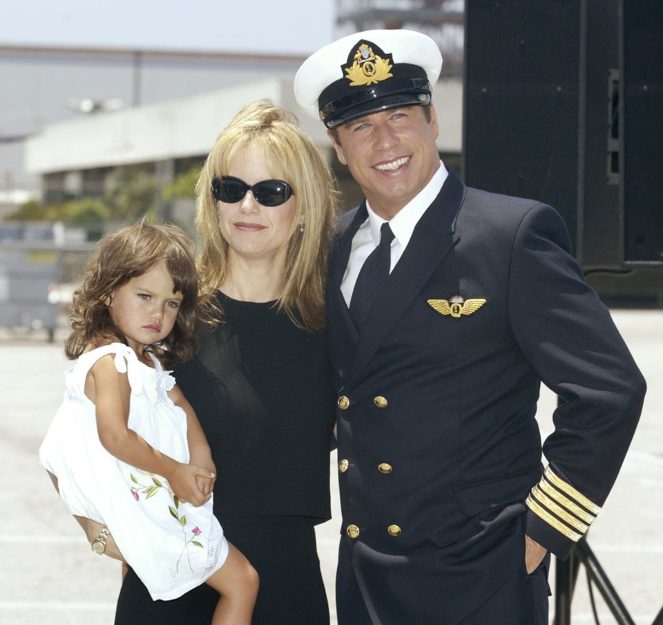 John Travolta, Kelly Preston, and their daughter Ella Bleu at a press conference.