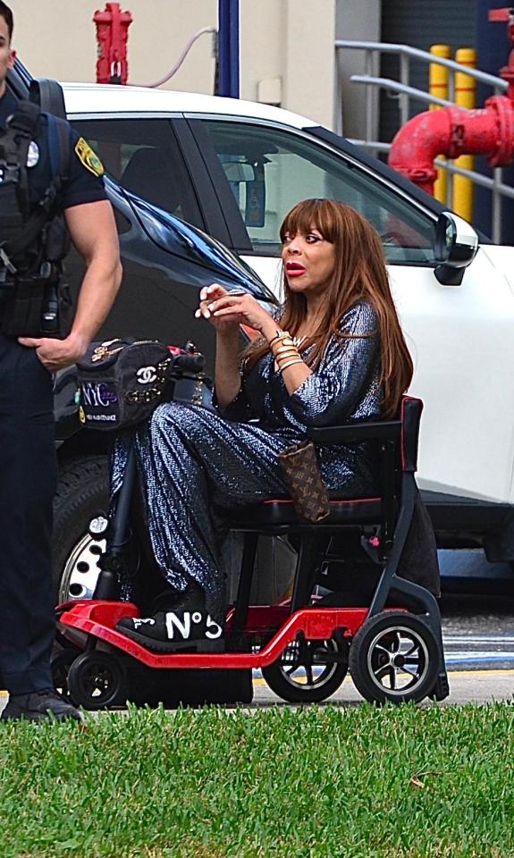 Wendy Williams in an electric wheelchair leaving her son's graduation.