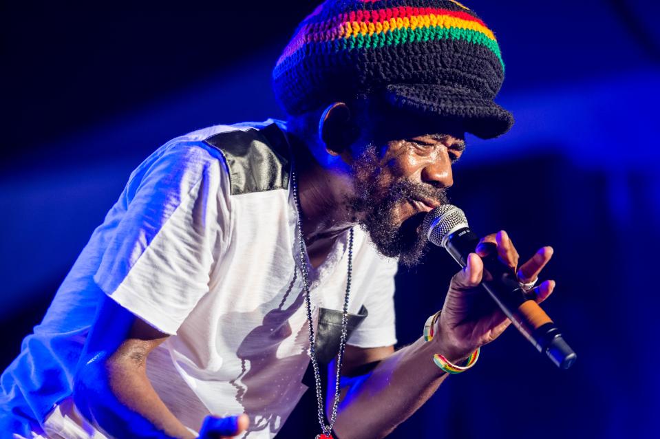 Cocoa Tea performing live at a concert.