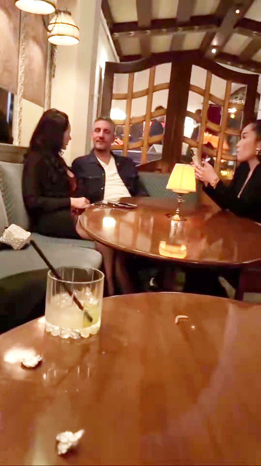 Three people sitting at a table in a restaurant.