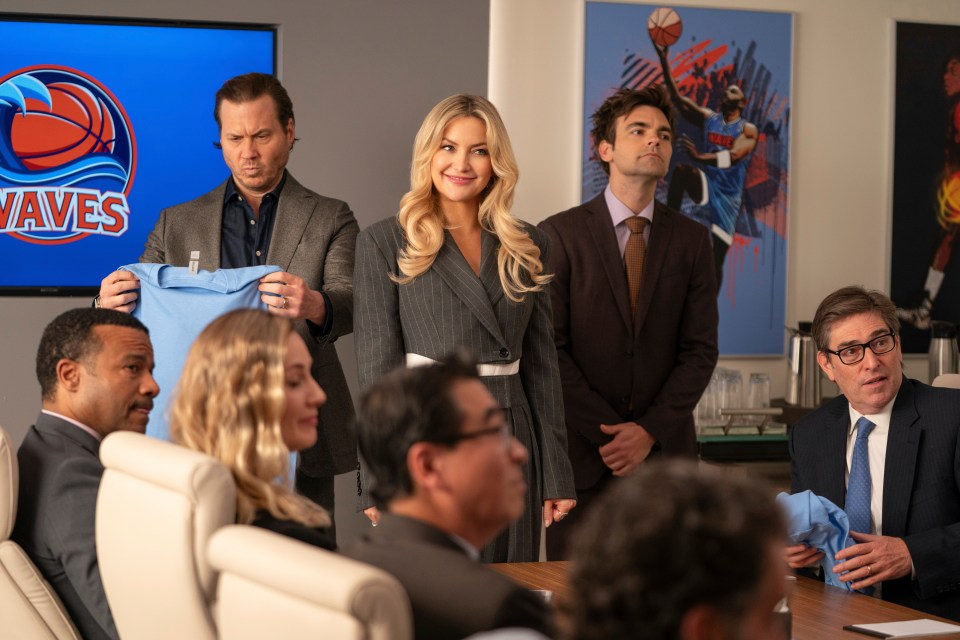 Scene from Running Point showing Kate Hudson and other cast members in a meeting.