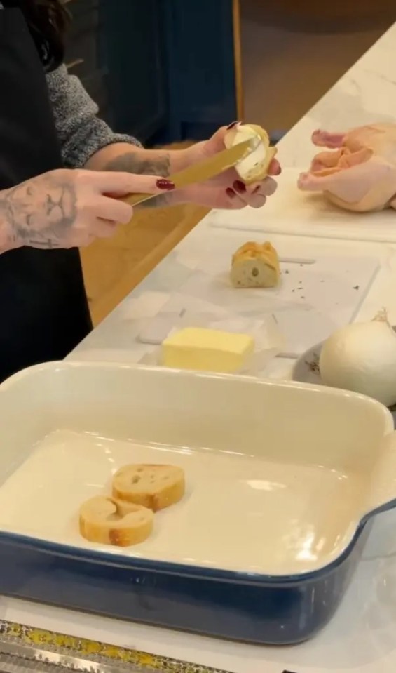 Person buttering bread in a kitchen.