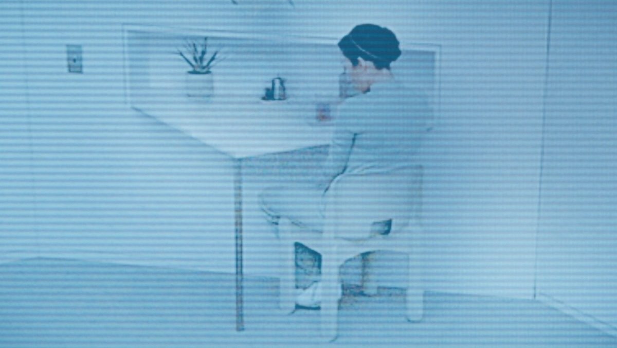 Gemma facing away from the camera in her cell seated on Severance season two, episode nine