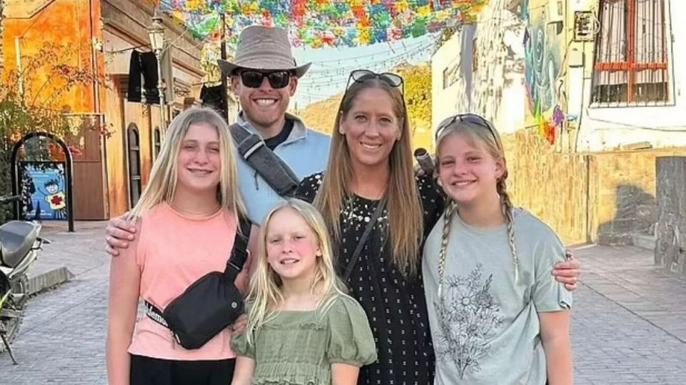 Family posing for a photo in a street.