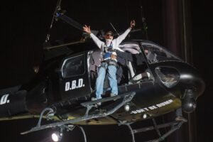 ASAP Rocky makes an entrance on a helicopter hoisted by a crane.