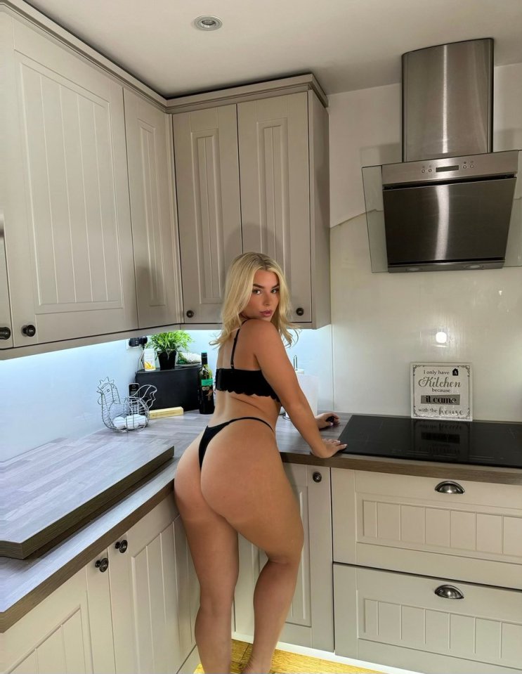 Woman in lingerie in a kitchen.