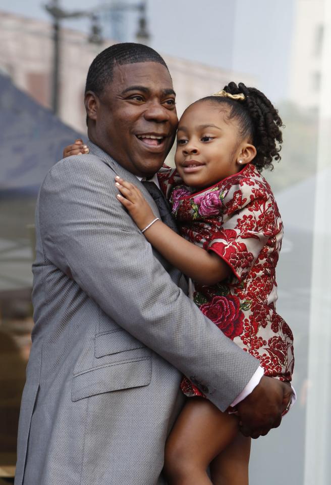 Tracy Morgan holding his daughter.