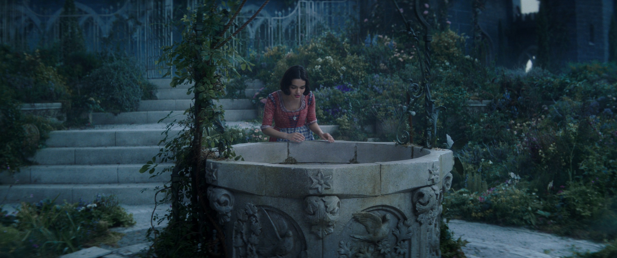 Snow White leans over her abandoned wishing well in Snow White