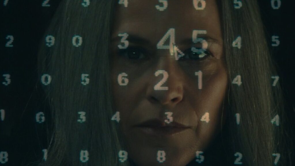 Harmony Cobel with NDR numbers super imposed on her face on Severance