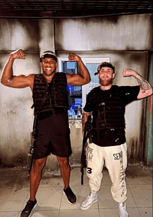 Anthony Joshua and Jake Paul flexing their biceps.