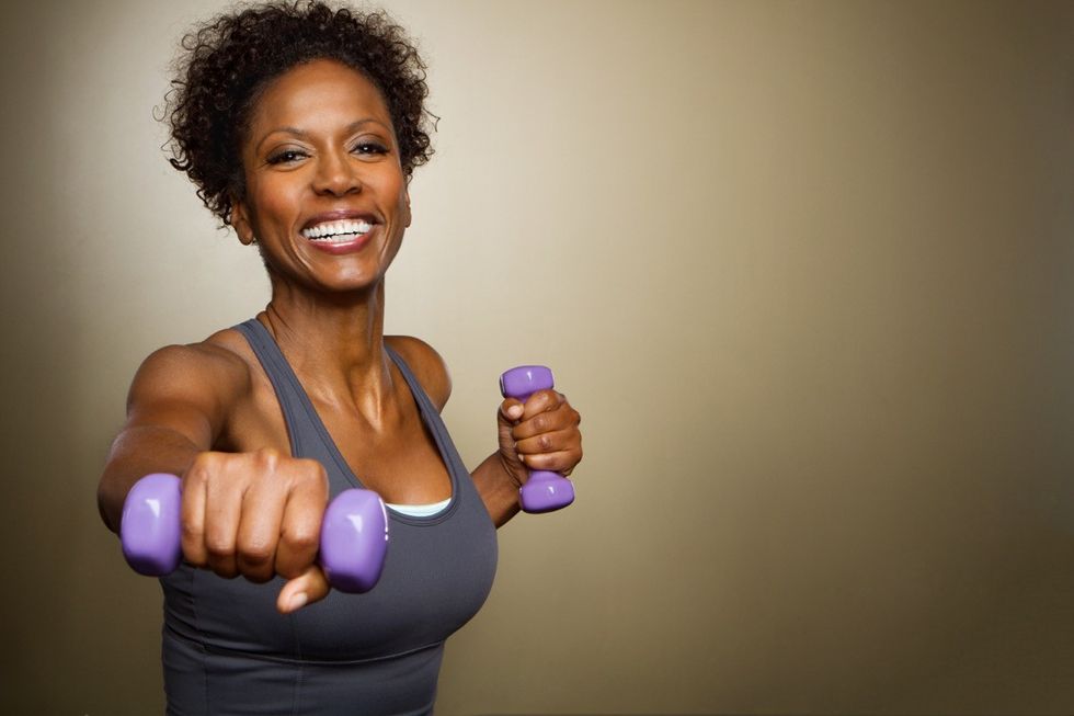 Woman lifting weights doing exercises