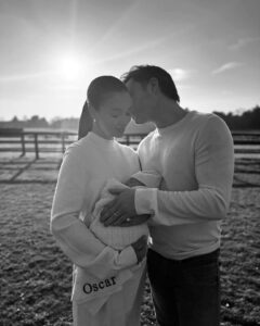 Amy Jackson and her partner holding their newborn baby, Oscar.