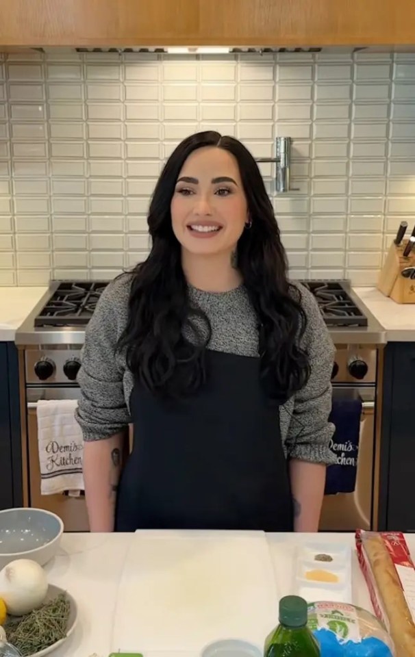 Demi Lovato in her kitchen preparing food.