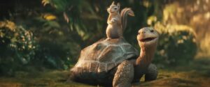 A CG tortoise smiles with a chipmunk perched on its back. From the 2025 live-action Snow White.