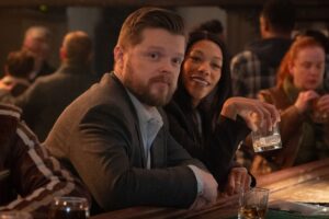 In a still from Daredevil: Born Again, Foggy Nelson (played by Elden Henson) leans against a bar and looks toward the camera.