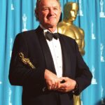 Gene Hackman holding an Academy Award.