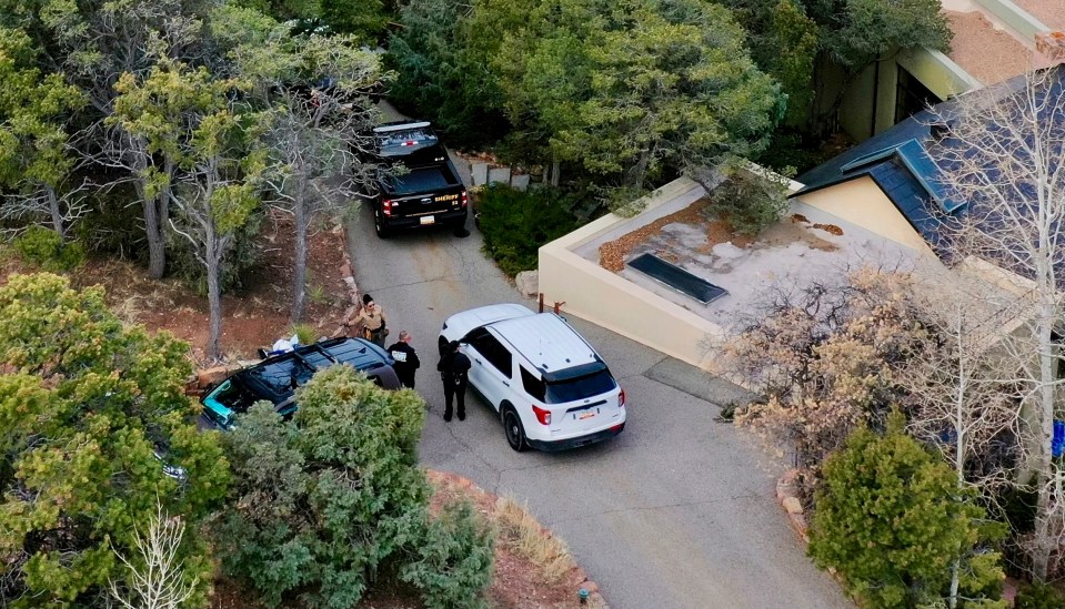 Law enforcement officers outside Gene Hackman's home in Santa Fe, New Mexico.