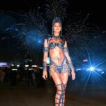 Woman in elaborate blue and black carnival costume.