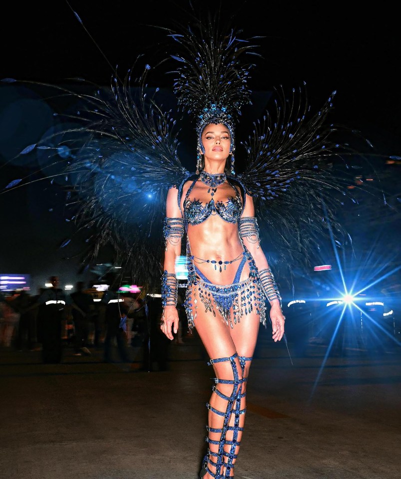 Woman in elaborate blue and black carnival costume.