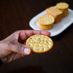 Woman Snacks on Crackers