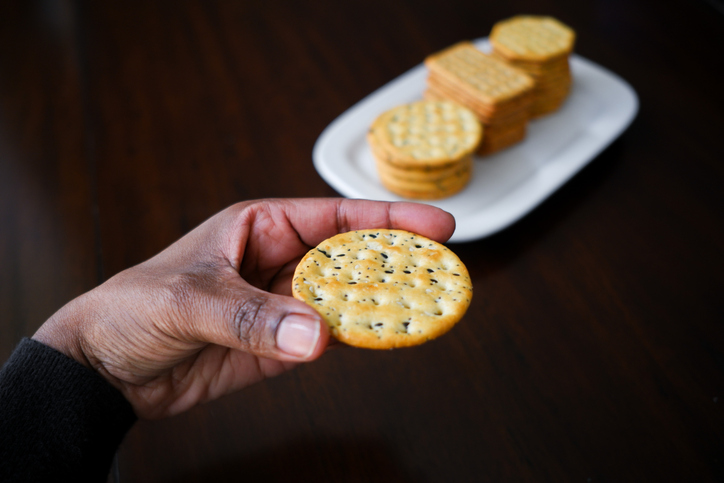 Woman Snacks on Crackers