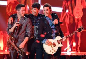 The Jonas Brothers performing onstage.