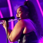 Lizzo playing the flute onstage