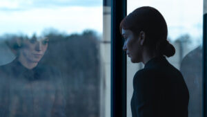 Helena Eagan (Britt Lower) looks out of the window in the Lumon building