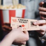 Passing Tickets To Movie Theater Worker