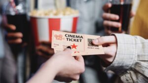 Passing Tickets To Movie Theater Worker