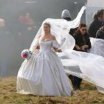 Margot Robbie in a wedding dress on the set of *Wuthering Heights*.