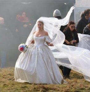 Margot Robbie in a wedding dress on the set of *Wuthering Heights*.