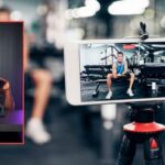 man working out at the gym and filming it for social media content