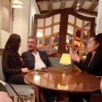 Mauricio Umansky with two women at a table in a restaurant.